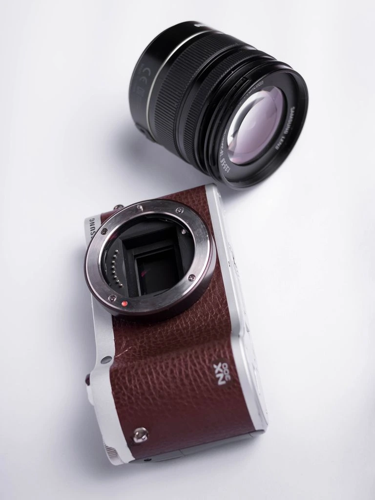 A mirrorless camera body opened to expose the IBIS unit and mainboard.